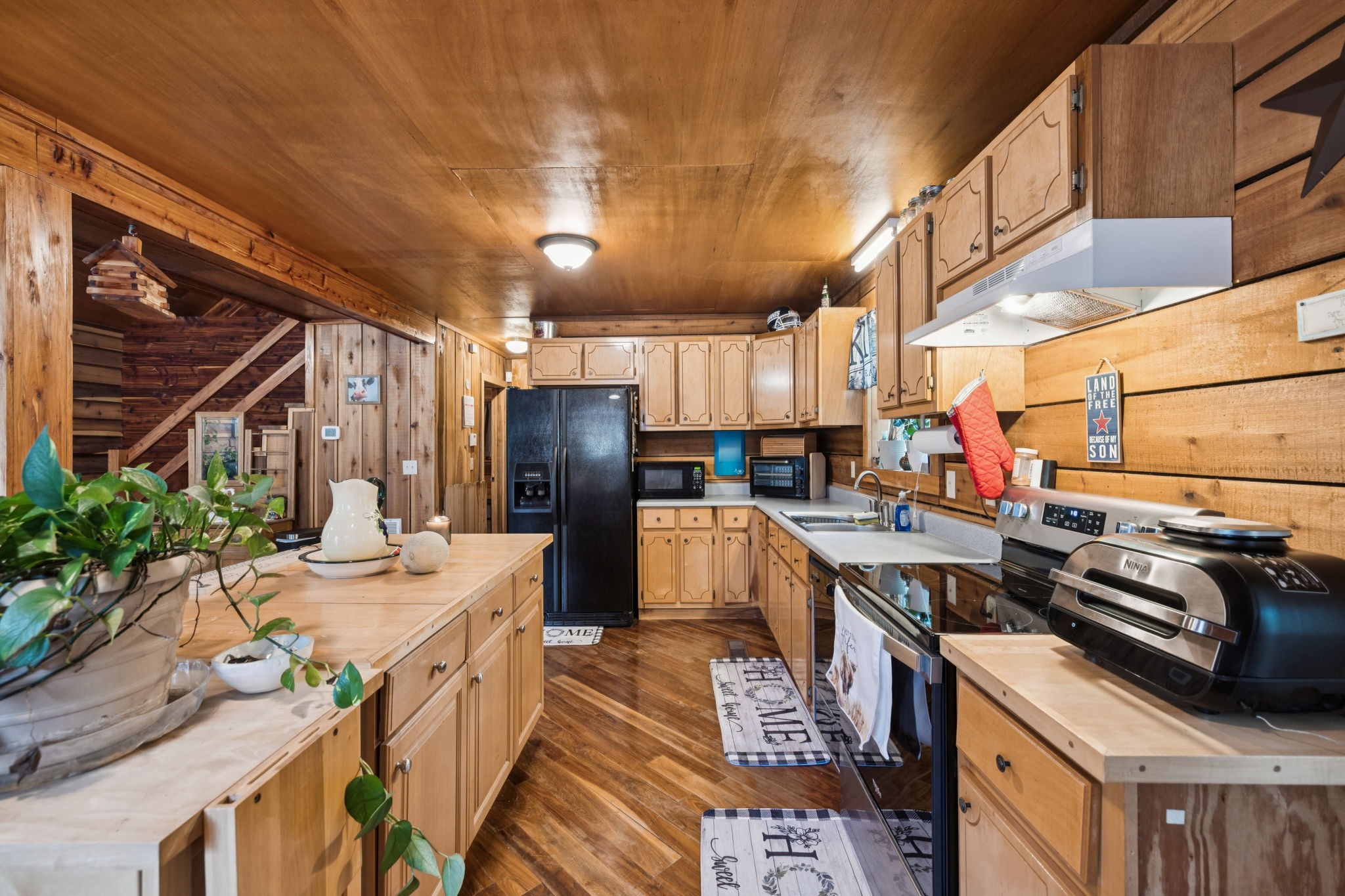 176 Robert Hensley Road Hohenwald, TN 38462 - Photo 15 of 53 a kitchen with stainless steel appliances a stove refrigerator sink and cabinets