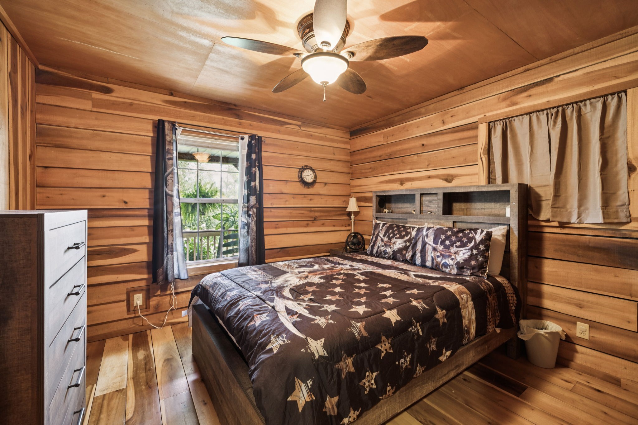 176 Robert Hensley Road Hohenwald, TN 38462 - Photo 17 of 53 a bedroom with a large bed and a chandelier