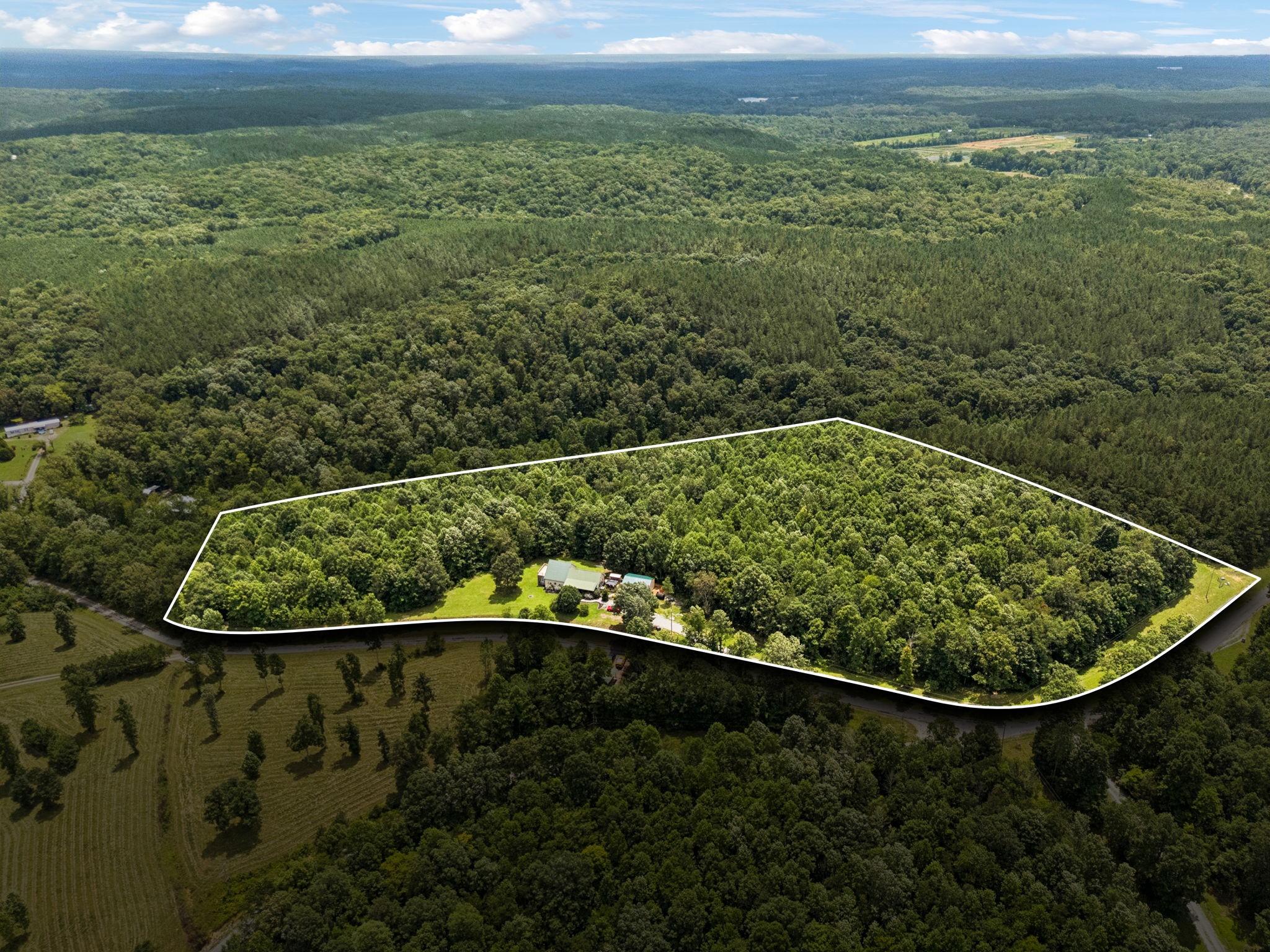 176 Robert Hensley Road Hohenwald, TN 38462 - Photo 2 of 53 a view of a back yard from a mirror