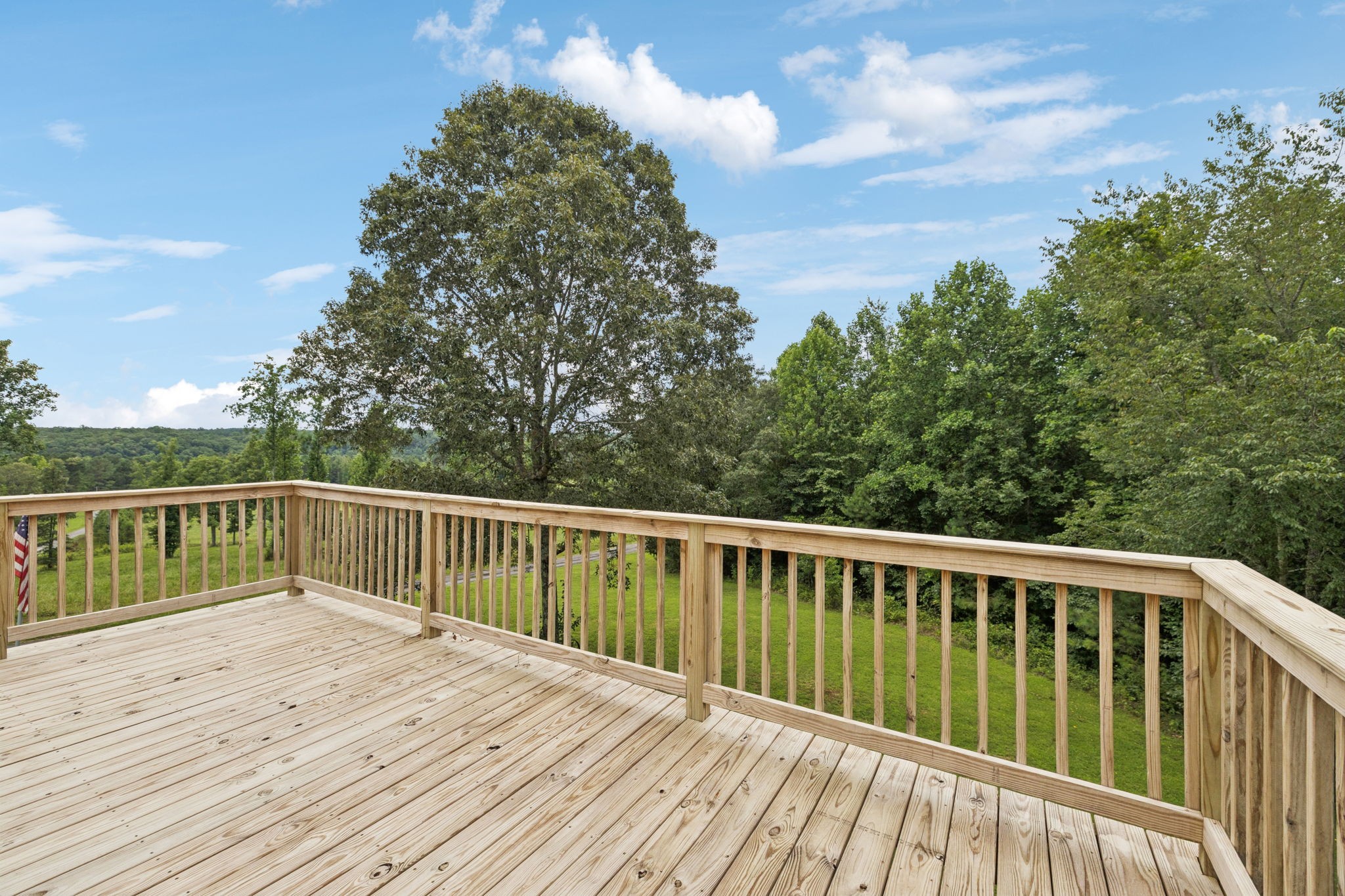176 Robert Hensley Road Hohenwald, TN 38462 - Photo 27 of 53 a balcony with wooden floor and fence