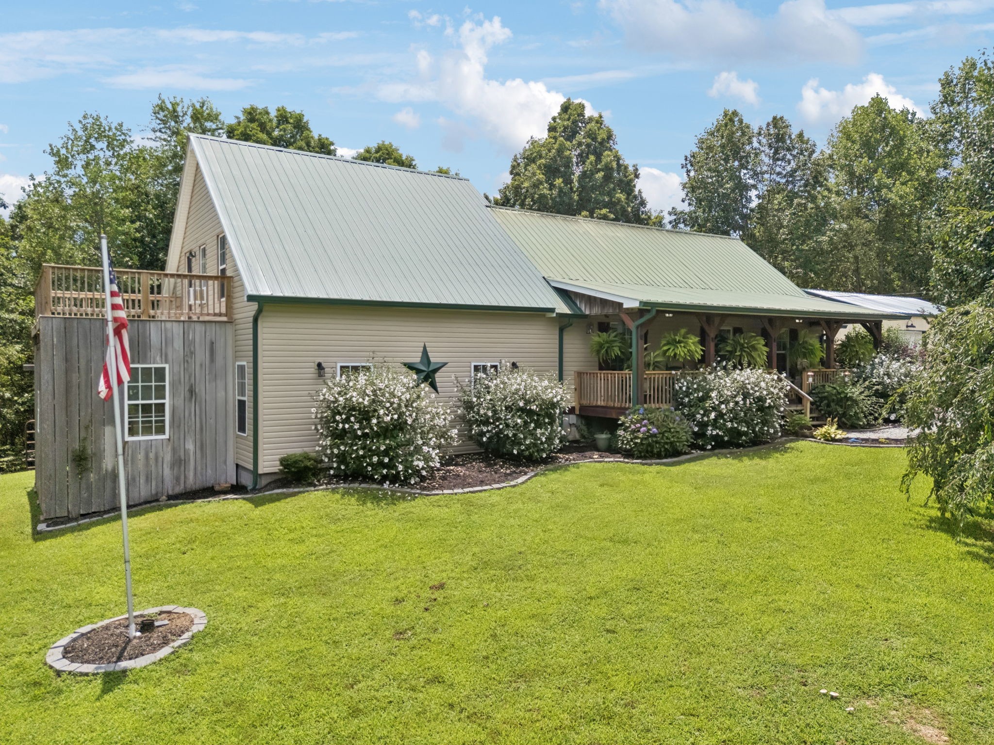 176 Robert Hensley Road Hohenwald, TN 38462 - Photo 37 of 53 a house with garden in front of it