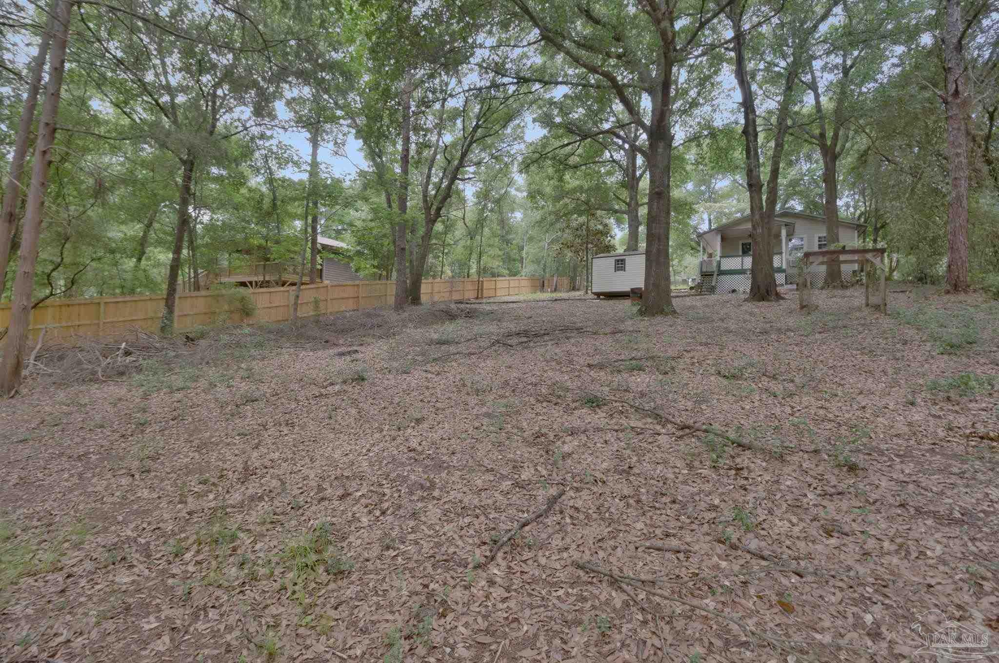 10290 West Lake Road Milton, FL 32583 - Photo 35 of 53 a view of a forest with trees in the background