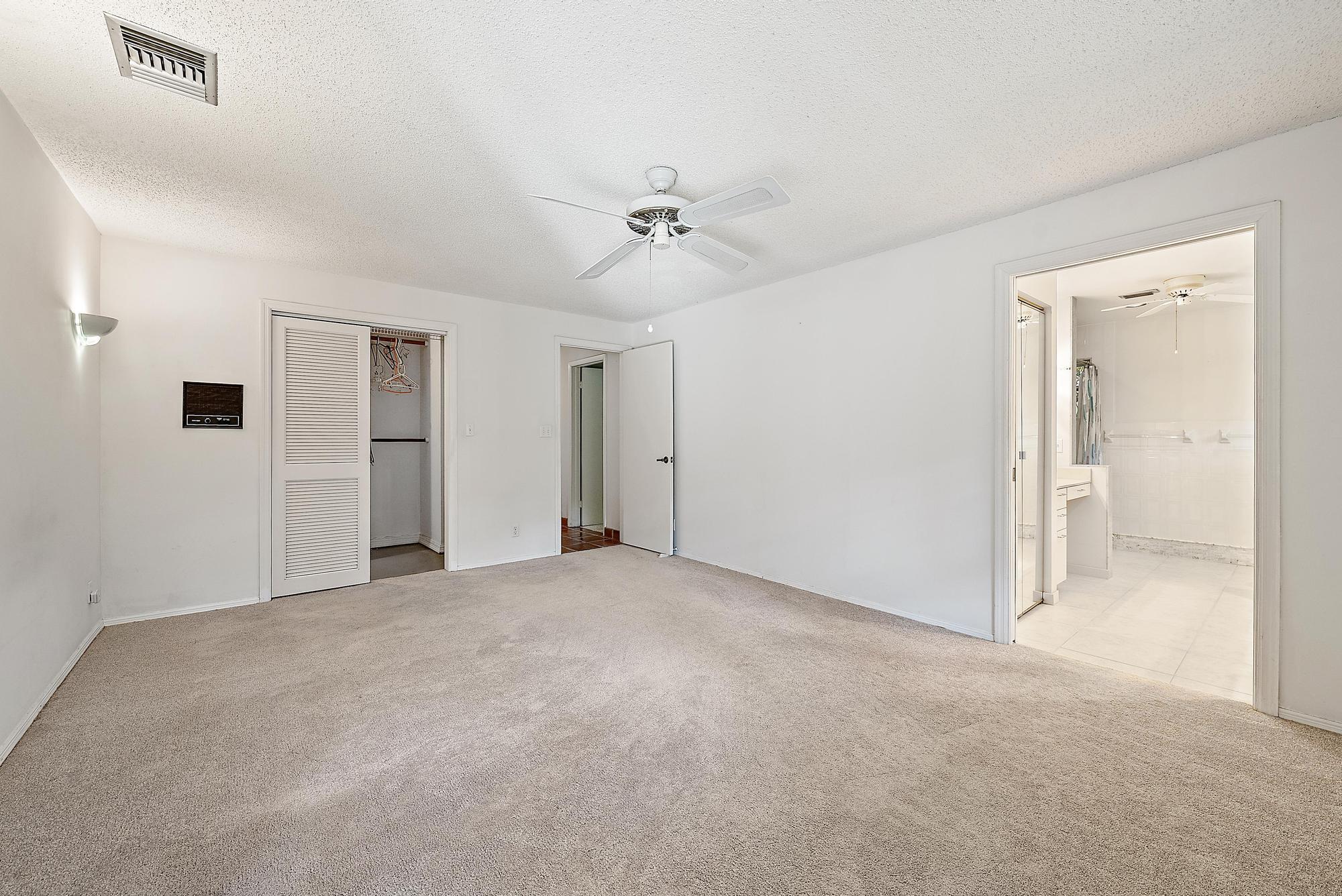 16486 95th Avenue North Jupiter, FL 33478 - Photo 11 of 34 an empty room with closet and a ceiling fan