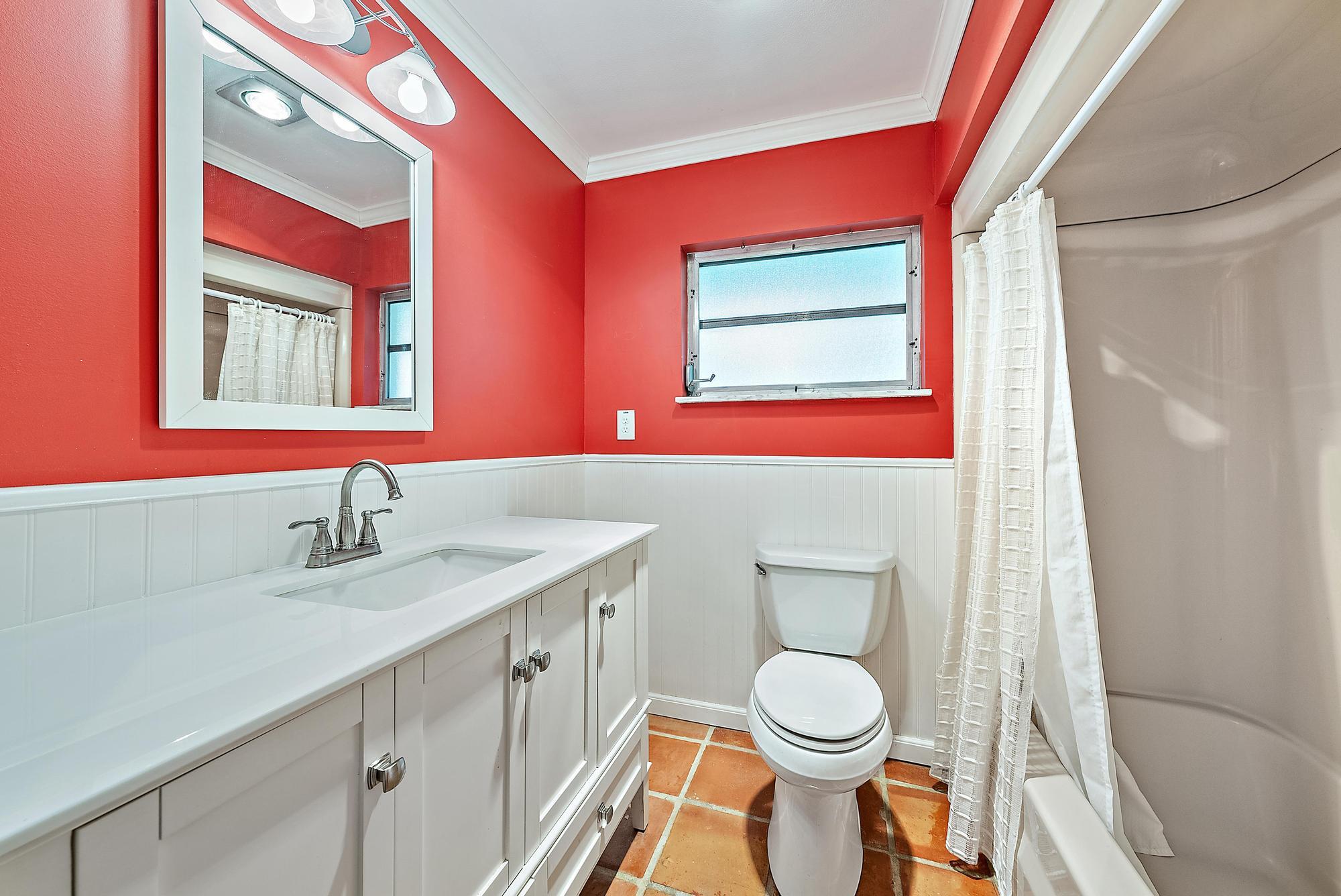 16486 95th Avenue North Jupiter, FL 33478 - Photo 16 of 34 a bathroom with a granite countertop toilet sink and mirror