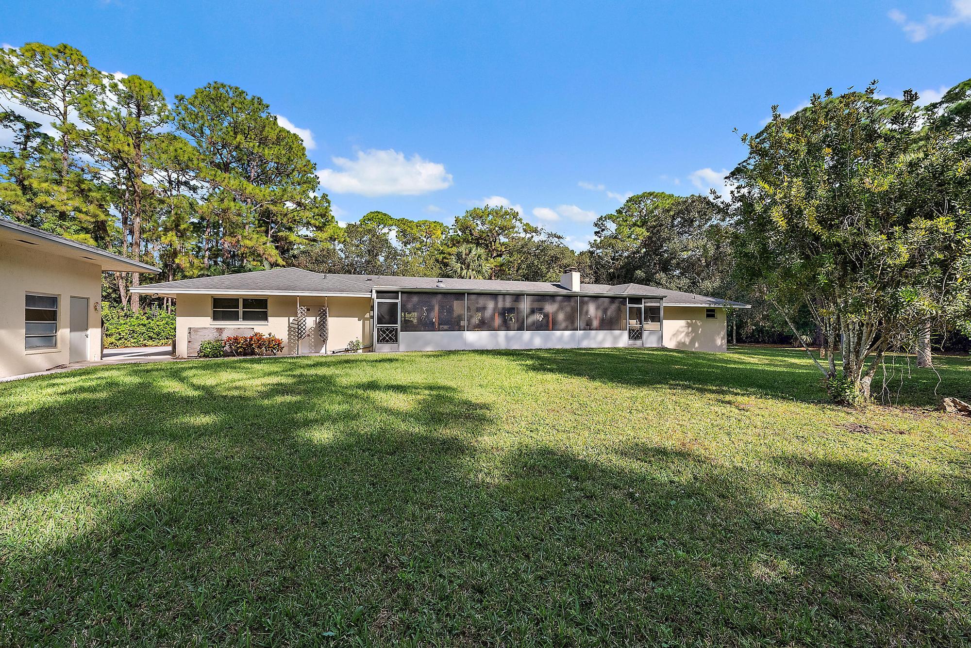 16486 95th Avenue North Jupiter, FL 33478 - Photo 24 of 34 a view of a house with a big yard