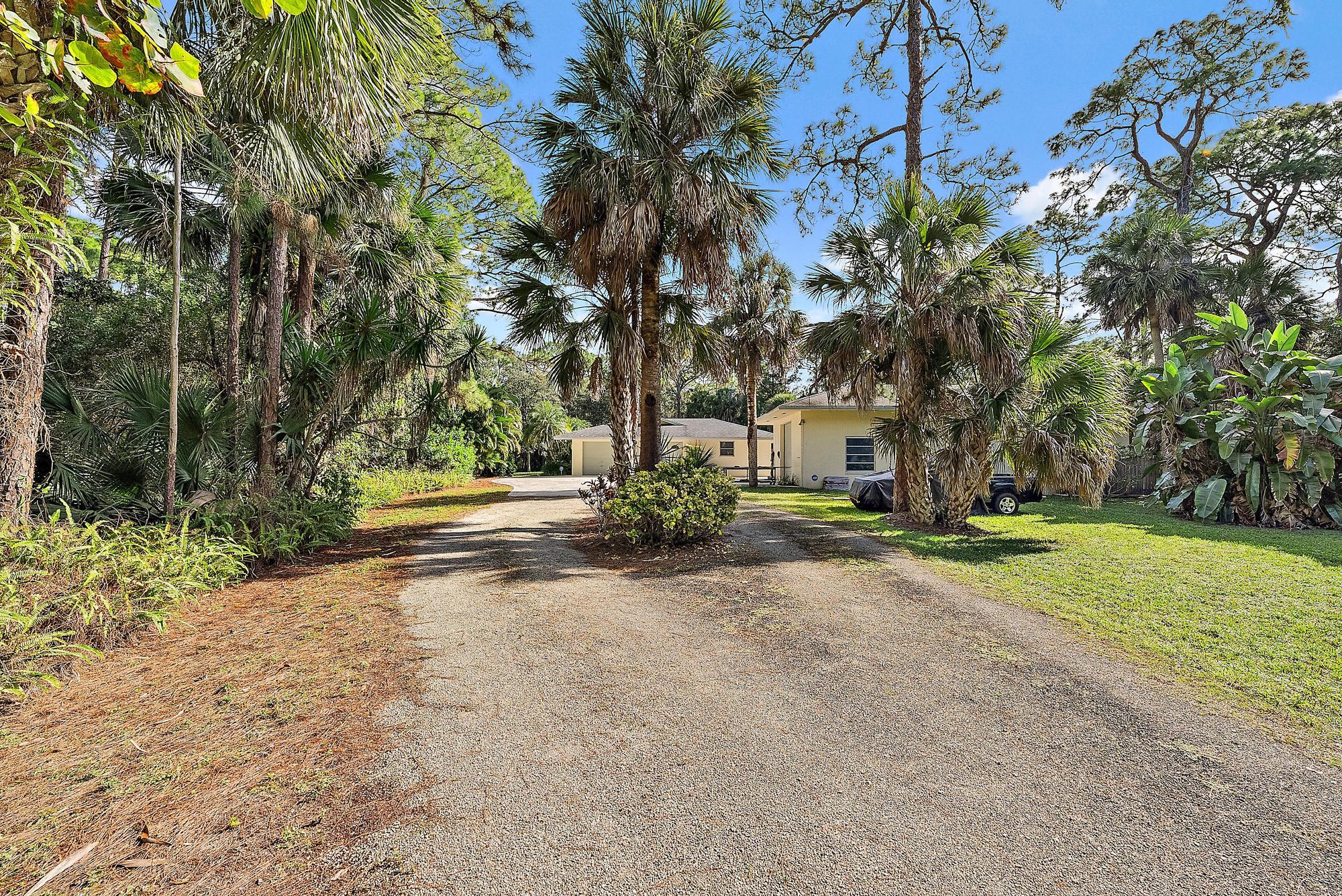 16486 95th Avenue North Jupiter, FL 33478 - Photo 29 of 34 a view of road with large trees