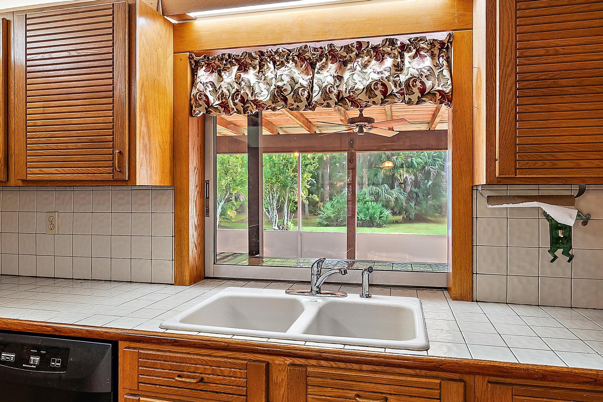 16486 95th Avenue North Jupiter, FL 33478 - Photo 7 of 34 a view of a kitchen with a sink and dishwasher kitchen view