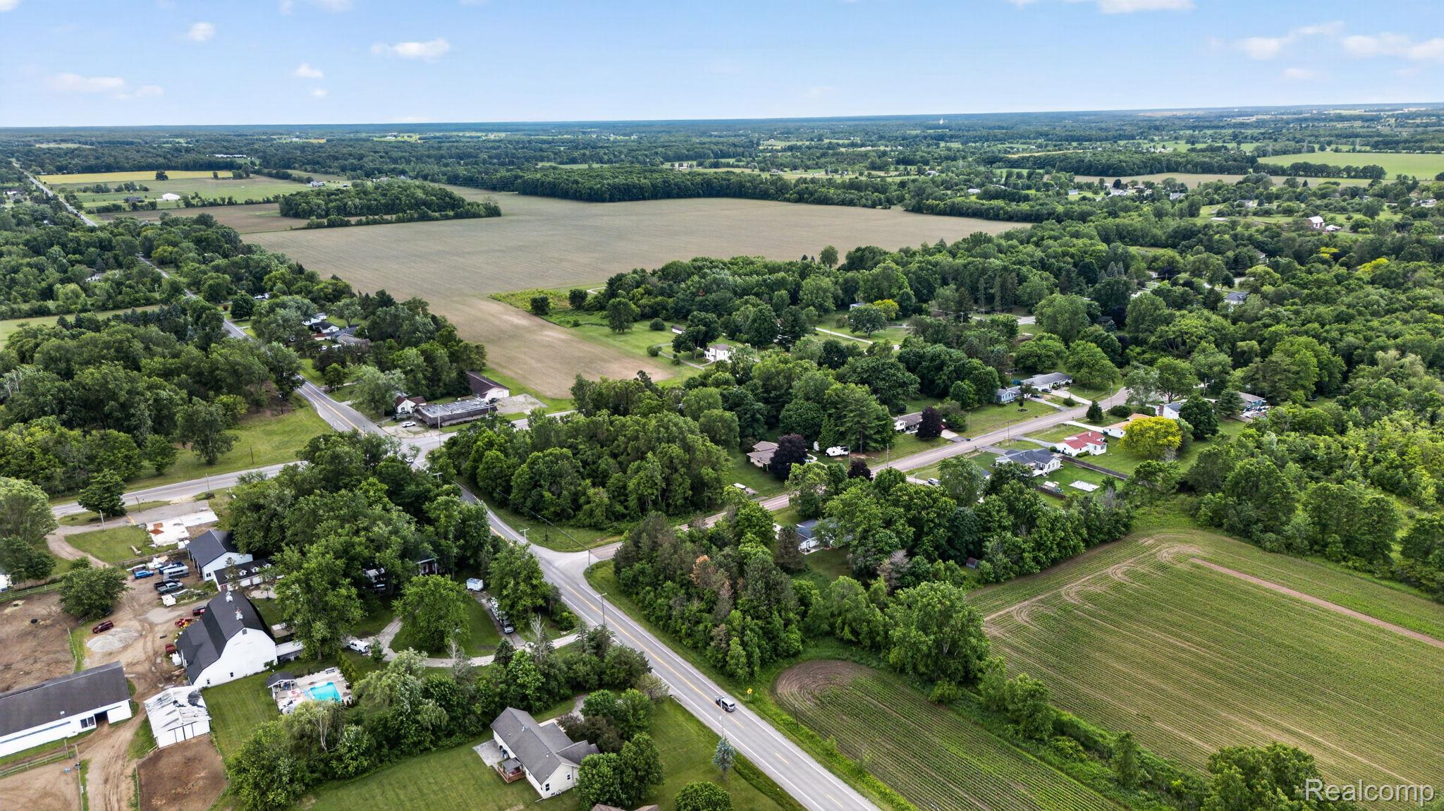 9288 Hilda Lane Flushing, MI 48433 - Photo 48 of 50 Aerial perspective showcasing a rural landscape with agricultural fields and wooded areas