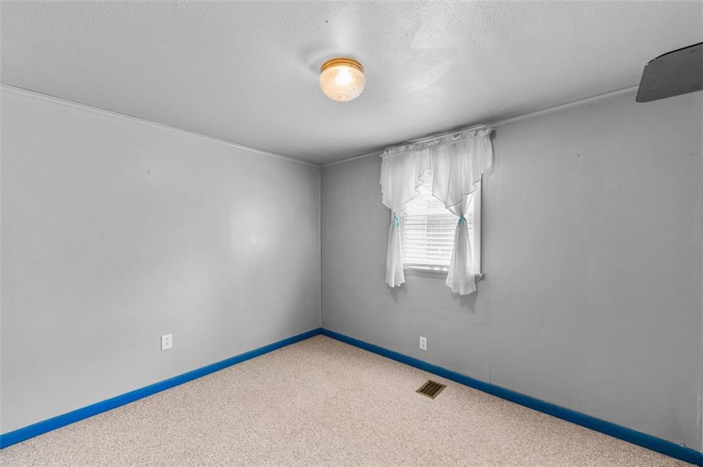 320 Cemetery Road Perryopolis, PA 15473 - Photo 13 of 18 a view of an empty room with a window and cabinets