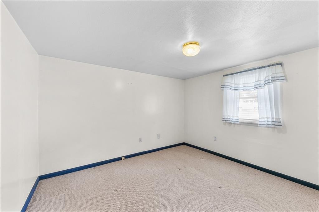 320 Cemetery Road Perryopolis, PA 15473 - Photo 14 of 18 wooden floor in an empty room with a window