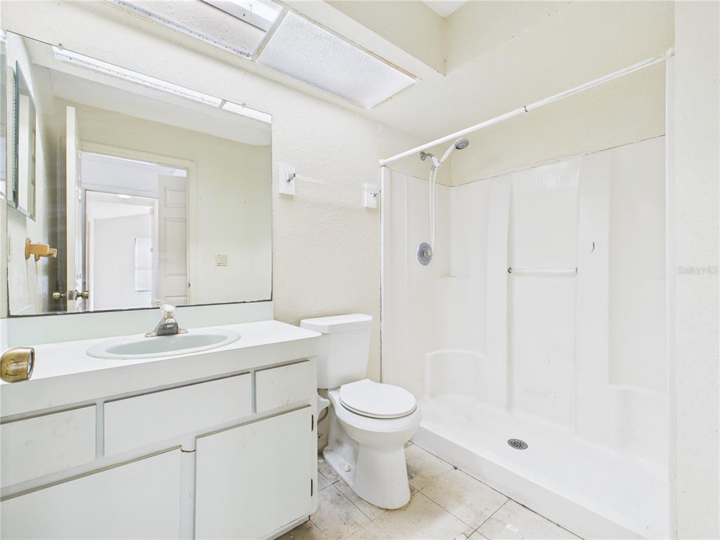4116 Jason Road Spring Hill, FL 34608 - Photo 11 of 66 a bathroom with a sink a toilet and shower