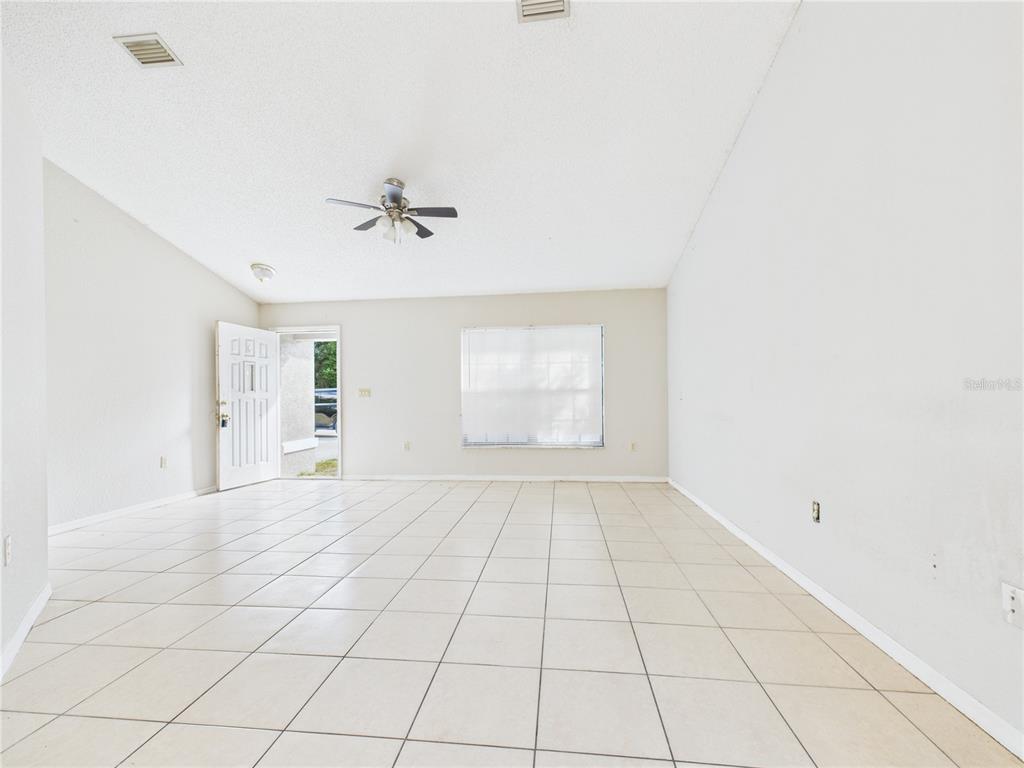 4116 Jason Road Spring Hill, FL 34608 - Photo 15 of 66 an empty room with windows and fan