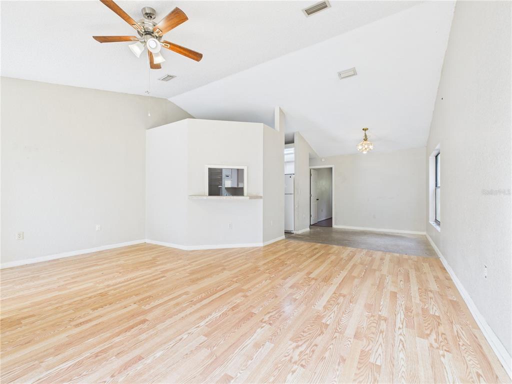 4116 Jason Road Spring Hill, FL 34608 - Photo 16 of 66 a view of empty room with wooden floor and fan