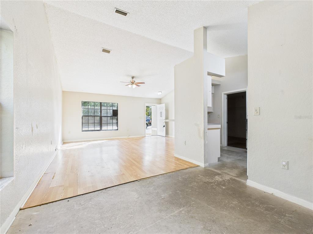 4116 Jason Road Spring Hill, FL 34608 - Photo 17 of 66 an empty room with windows and refrigerator