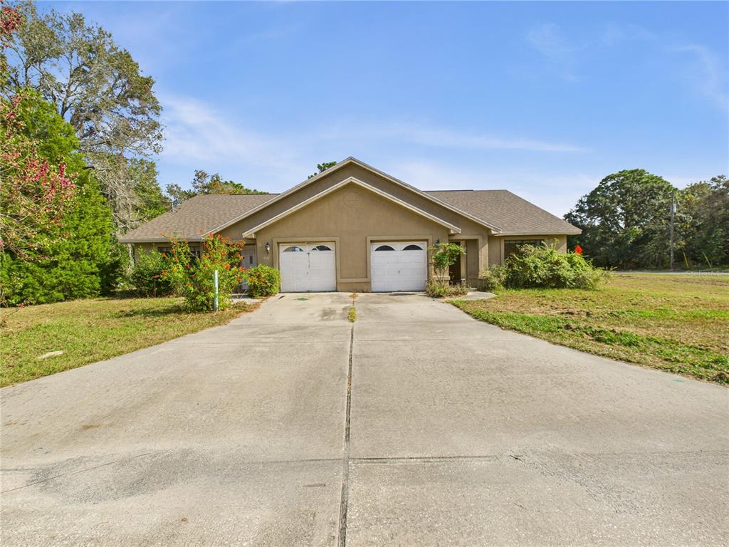4116 Jason Road Spring Hill, FL 34608 - Photo 2 of 66 a front view of a house with a yard