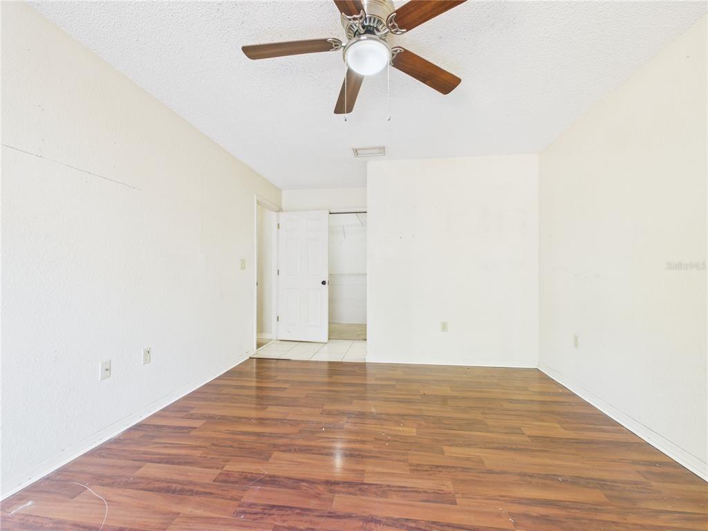4116 Jason Road Spring Hill, FL 34608 - Photo 23 of 66 a view of an empty room with wooden floor