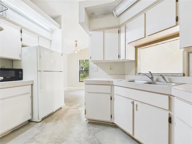 a view of a big room with wooden floor and windows