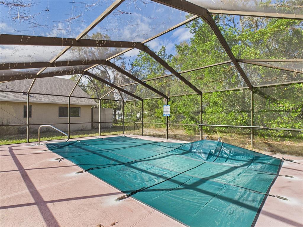 4116 Jason Road Spring Hill, FL 34608 - Photo 28 of 66 a view of a tennis ground with a swimming pool