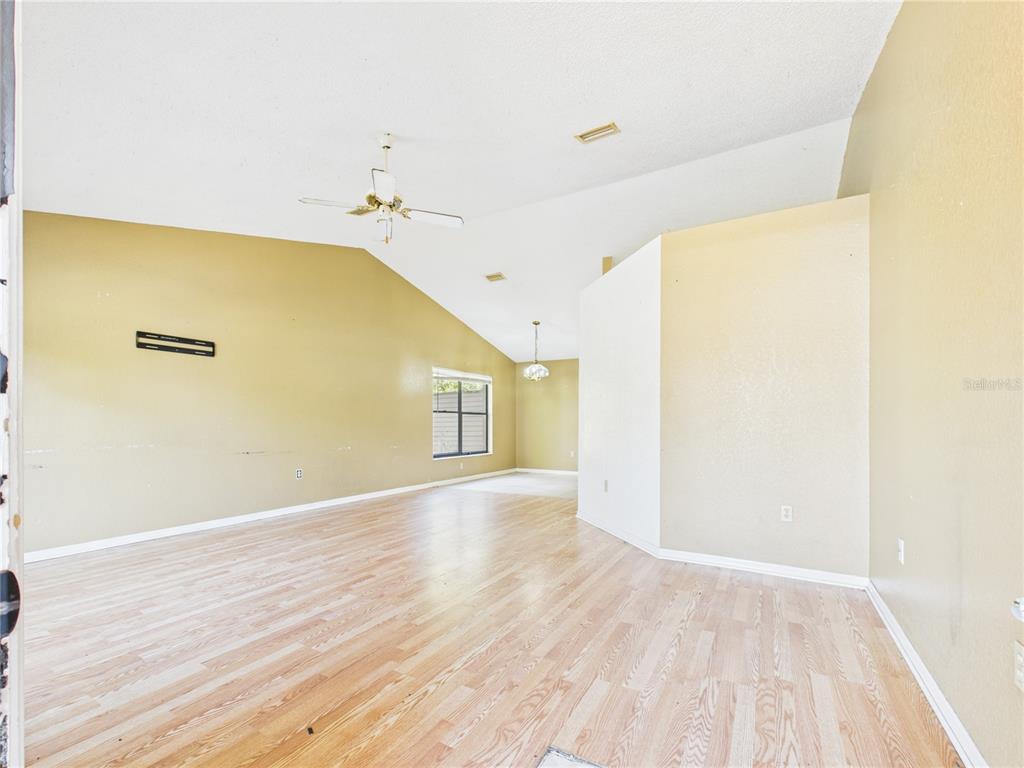4116 Jason Road Spring Hill, FL 34608 - Photo 32 of 66 a view of a big room with wooden floor and windows