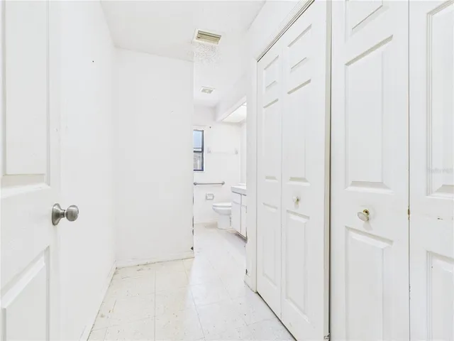 a kitchen with white cabinets and white appliances