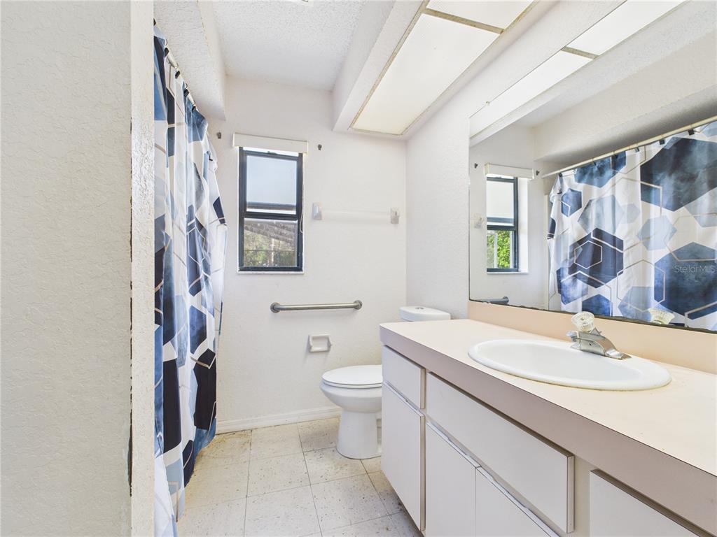 4116 Jason Road Spring Hill, FL 34608 - Photo 37 of 66 a bathroom with a sink toilet double vanity and shower