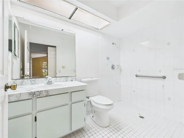 a bathroom with a sink a toilet a mirror and vanity