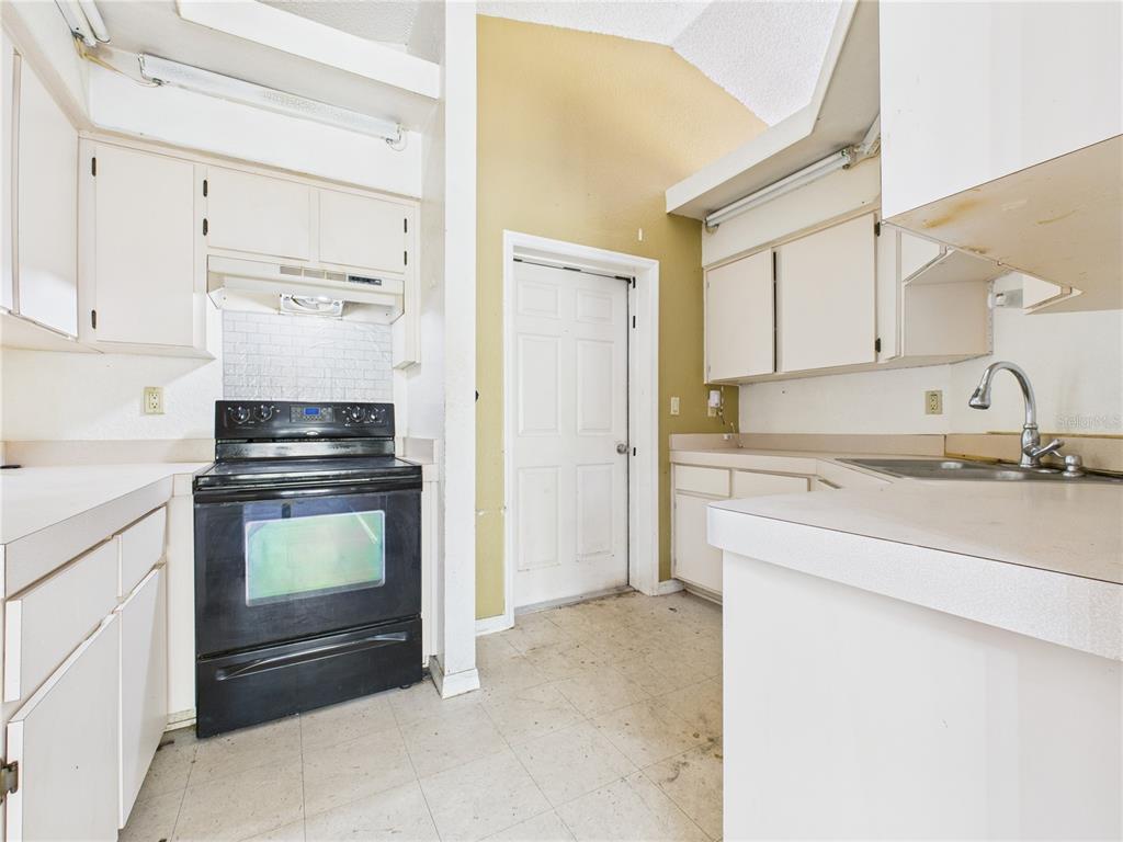 4116 Jason Road Spring Hill, FL 34608 - Photo 41 of 66 a kitchen with a sink stove and refrigerator
