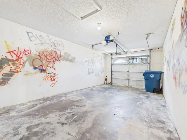 a bathroom with a granite countertop sink a toilet a mirror and shower