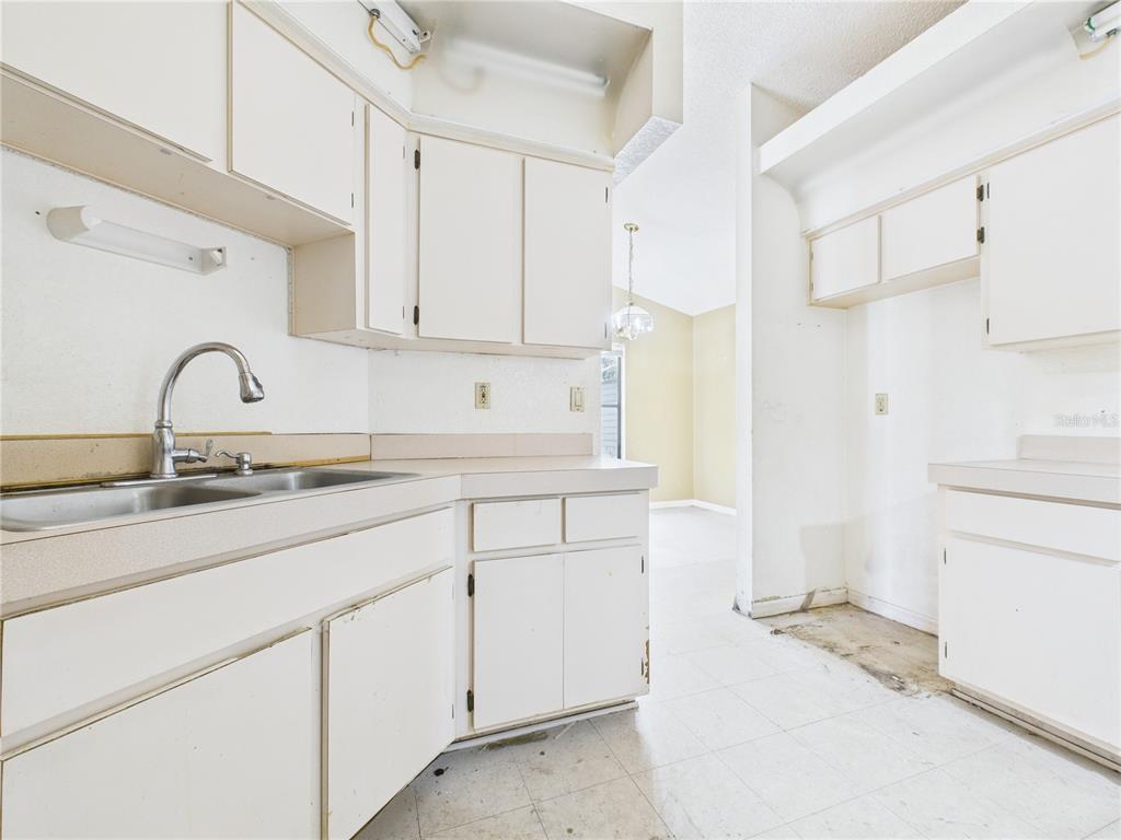 4116 Jason Road Spring Hill, FL 34608 - Photo 43 of 66 a kitchen with a sink cabinets and appliances