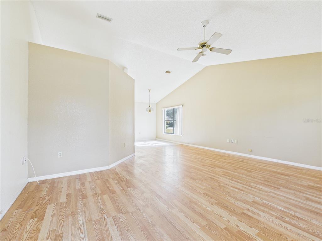 4116 Jason Road Spring Hill, FL 34608 - Photo 44 of 66 a view of a room with wooden floor and a ceiling fan