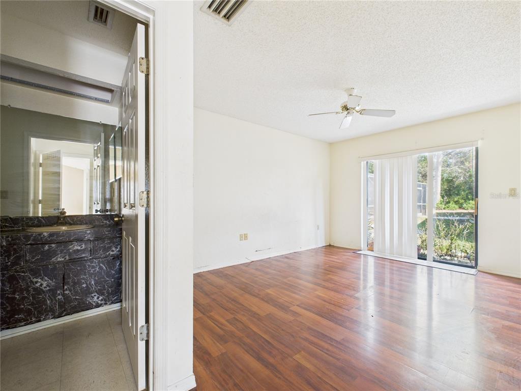 4116 Jason Road Spring Hill, FL 34608 - Photo 53 of 66 a view of an empty room with wooden floor and a window