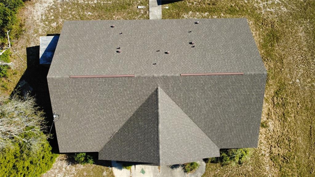 4116 Jason Road Spring Hill, FL 34608 - Photo 64 of 66 an aerial view of a large white building with trees in the background
