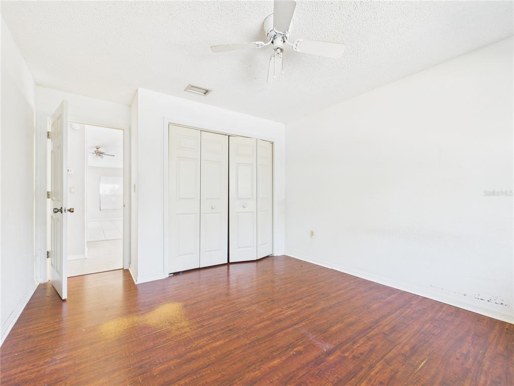 4116 Jason Road Spring Hill, FL 34608 - Photo 7 of 66 a view of an empty room with wooden floor
