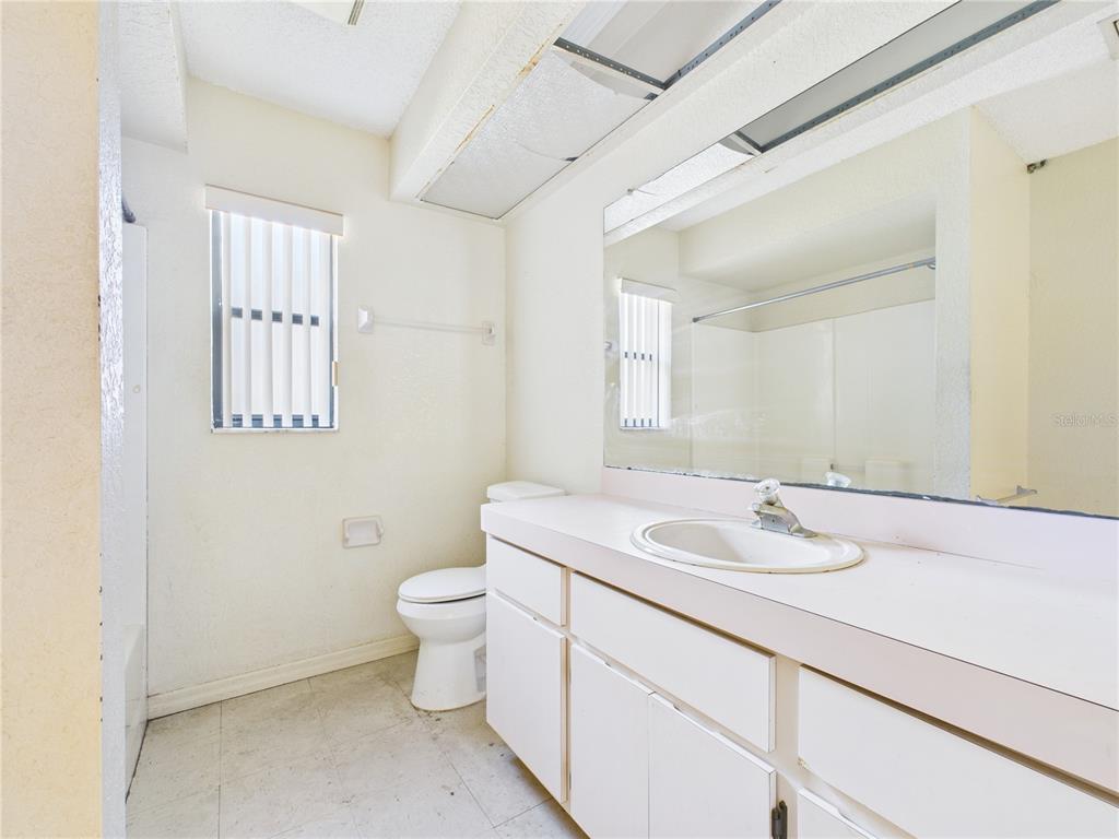 4116 Jason Road Spring Hill, FL 34608 - Photo 8 of 66 a bathroom with a sink toilet and mirror