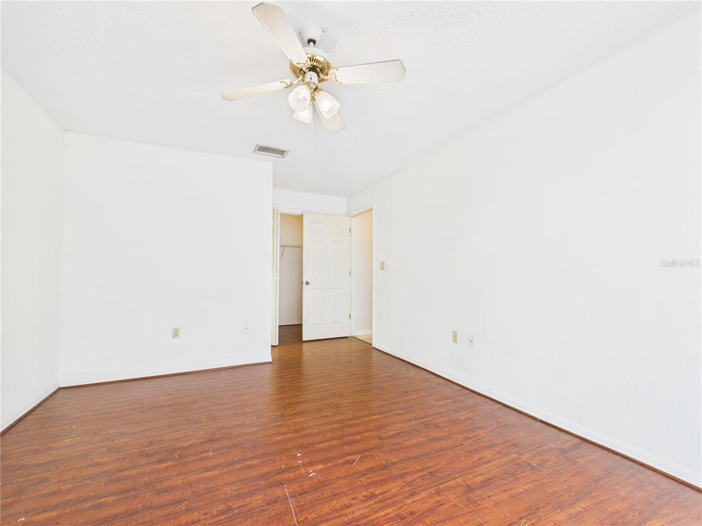 4116 Jason Road Spring Hill, FL 34608 - Photo 10 of 66 a view of an empty room with wooden floor