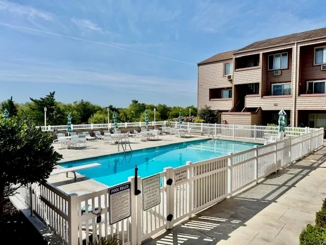 a view of swimming pool with outdoor seating and plants