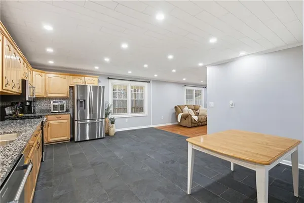 a view of a kitchen with refrigerator and workspace
