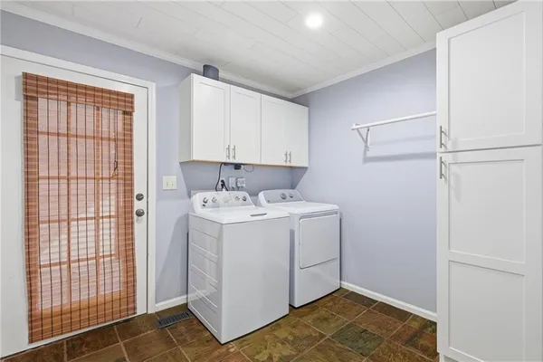 a view of utility room with closet and windows