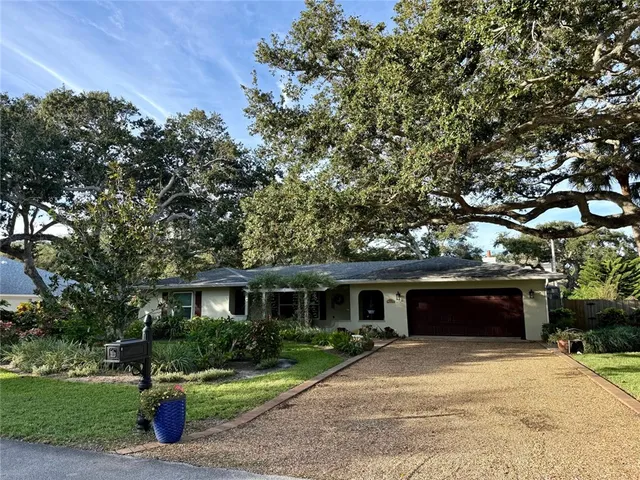 a front view of a house with a yard and a garage