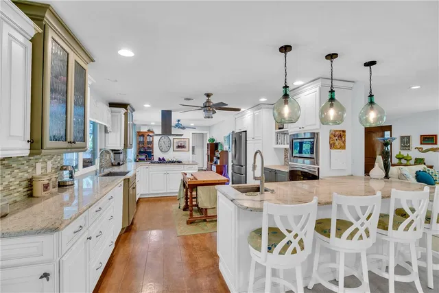 a kitchen with a stove a sink and a refrigerator