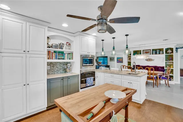 a kitchen with stainless steel appliances kitchen island granite countertop a sink and cabinets