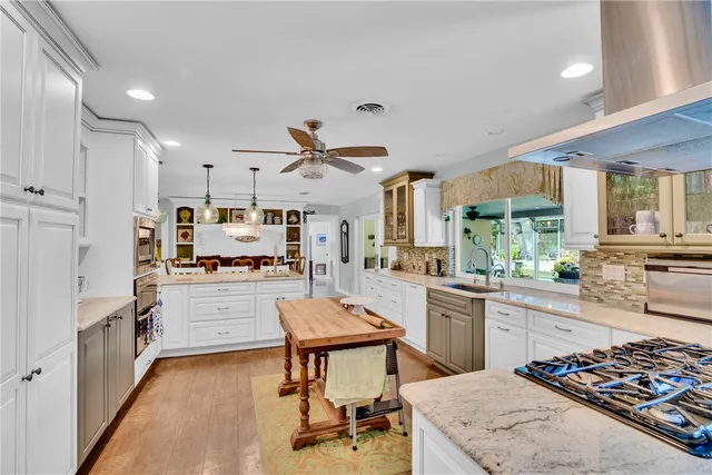 a living room with furniture flat screen tv and a large window