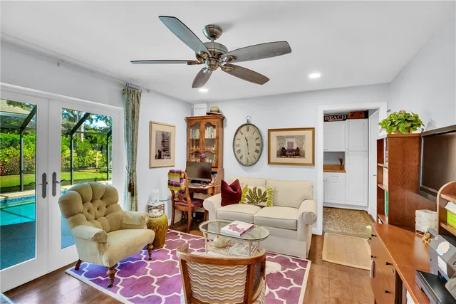 a living room with furniture and kitchen view