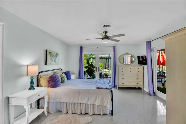 a bathroom with mirror two sinks and a wooden floor