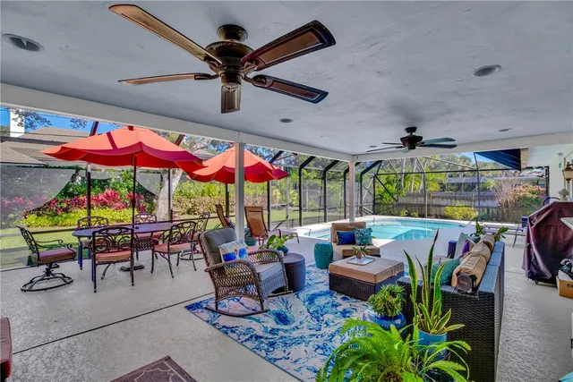 a view of a patio with a table and chairs under an umbrella