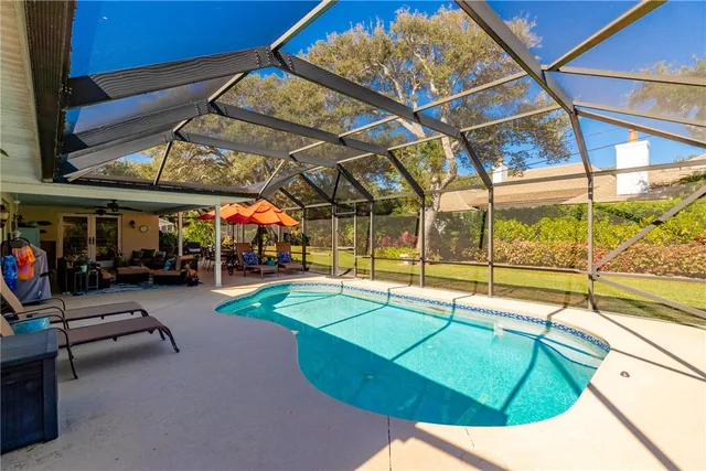 a view of a swimming pool with an outdoor space and seating area