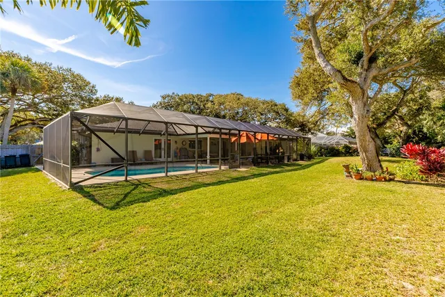 a view of a house with swimming pool and sitting area