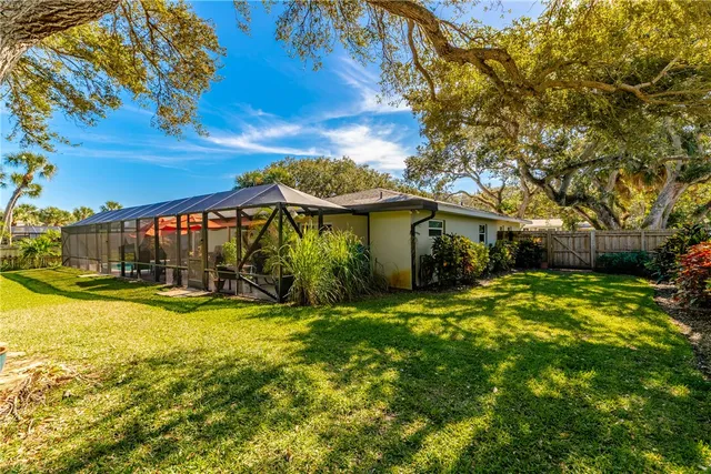 a view of a house with a yard and potted plants