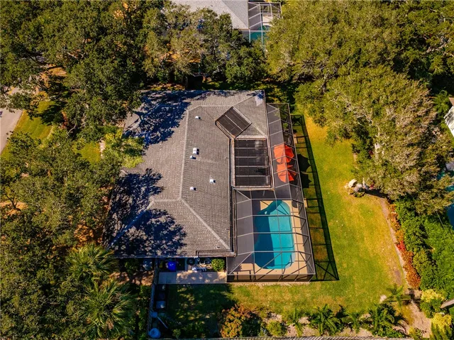 a view of a house with a yard and tree s