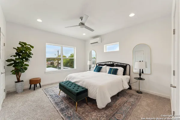 a bedroom with a bed and a potted plant
